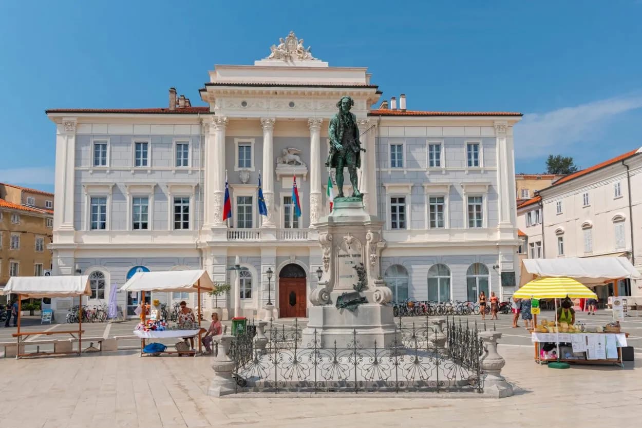 Statue in front of a neoclassical building in Tartini Square, Piran Old Town.