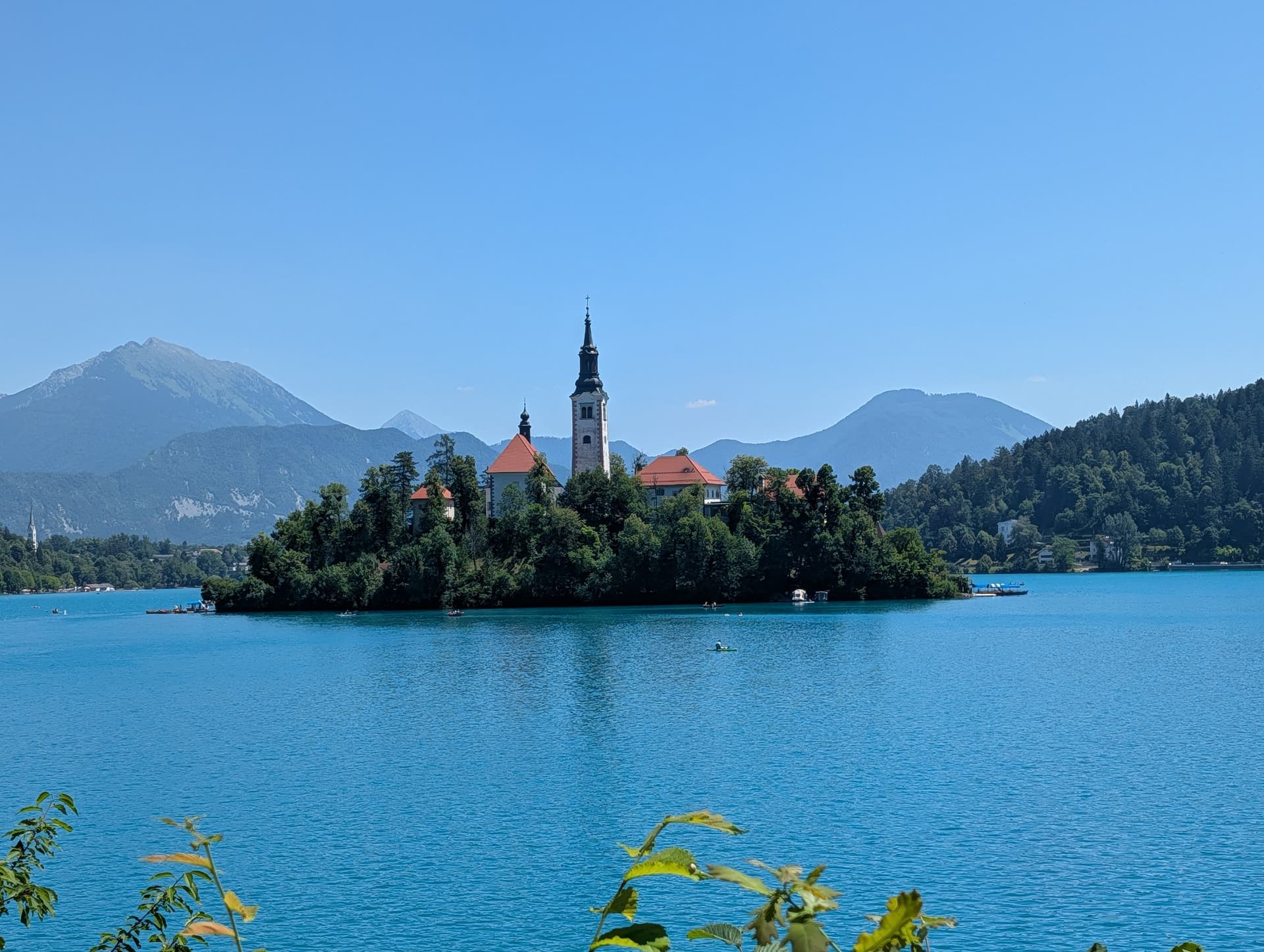Lake Bled island church in Slovenia with blue water and surrounding mountains