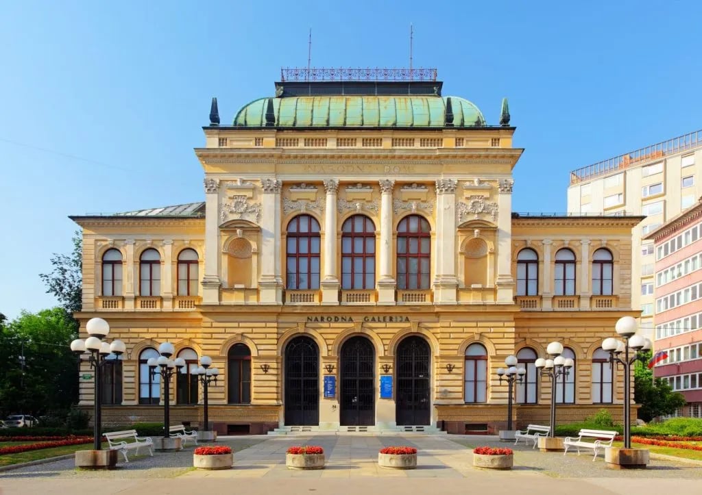 National Gallery (Narodna Galerija) building facade in Ljubljana under a clear blue sky.