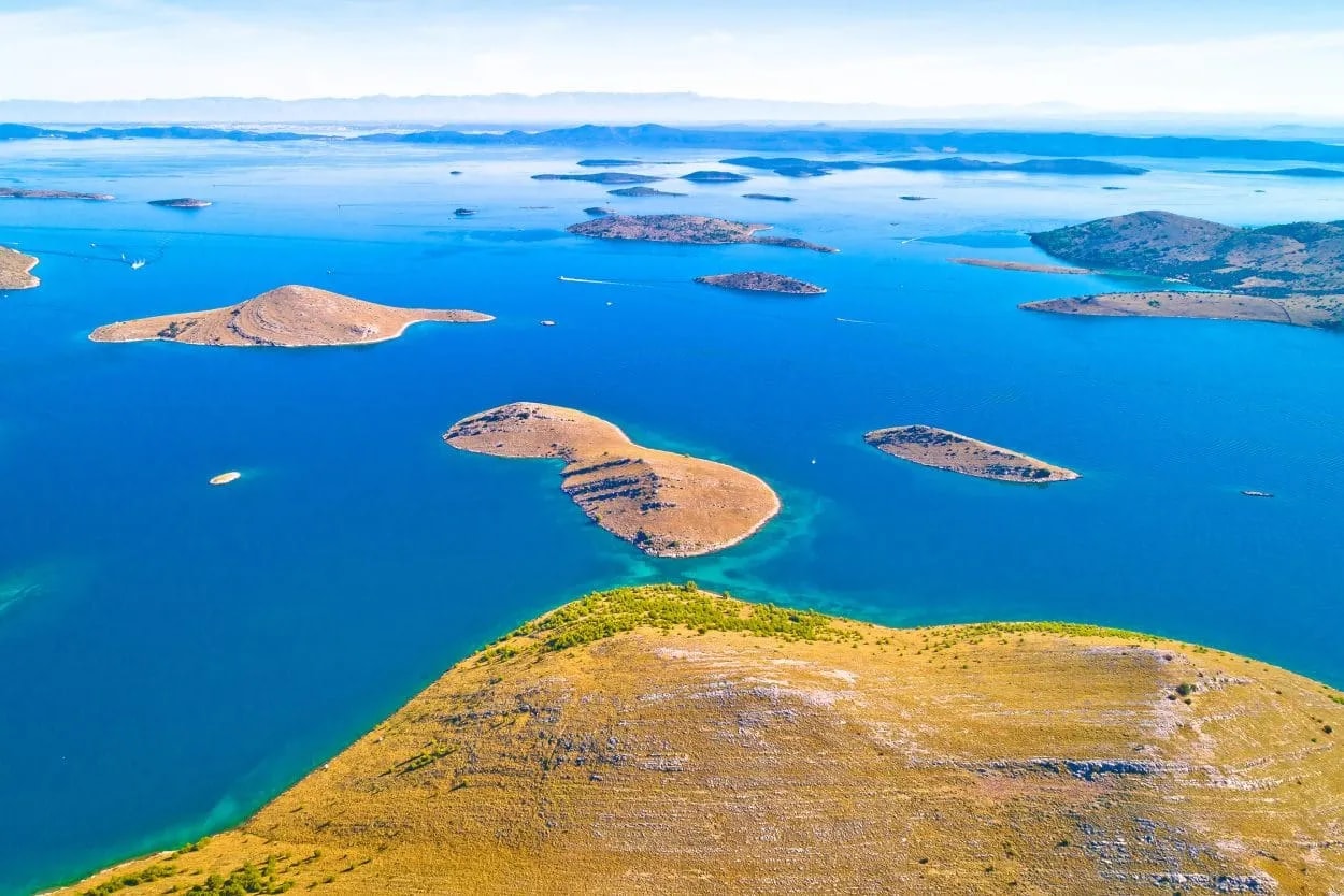 Aerial view of numerous arid islands in bright blue sea, Kornati National Park.