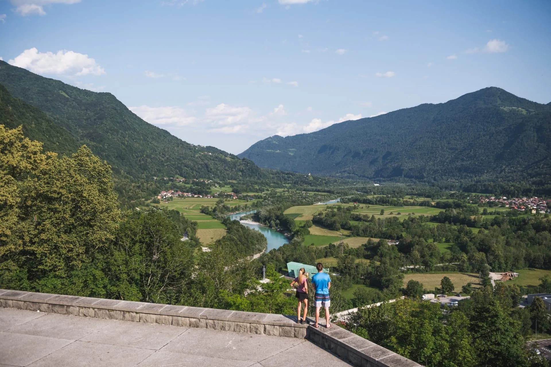 View of the Soca River valley and forested mountains from Kobarid ossuary viewpoint.