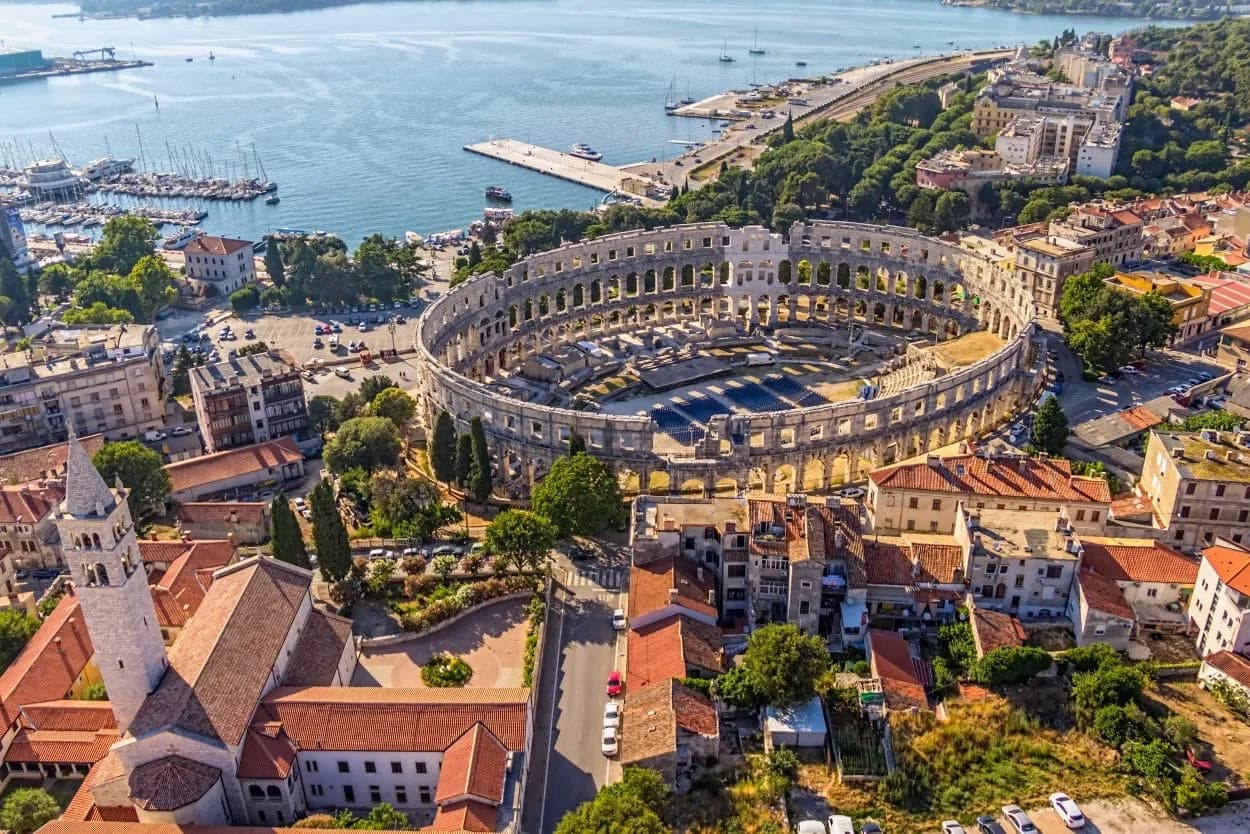 Aerial view of Pula Arena Roman amphitheater and harbor in Pula, Croatia.