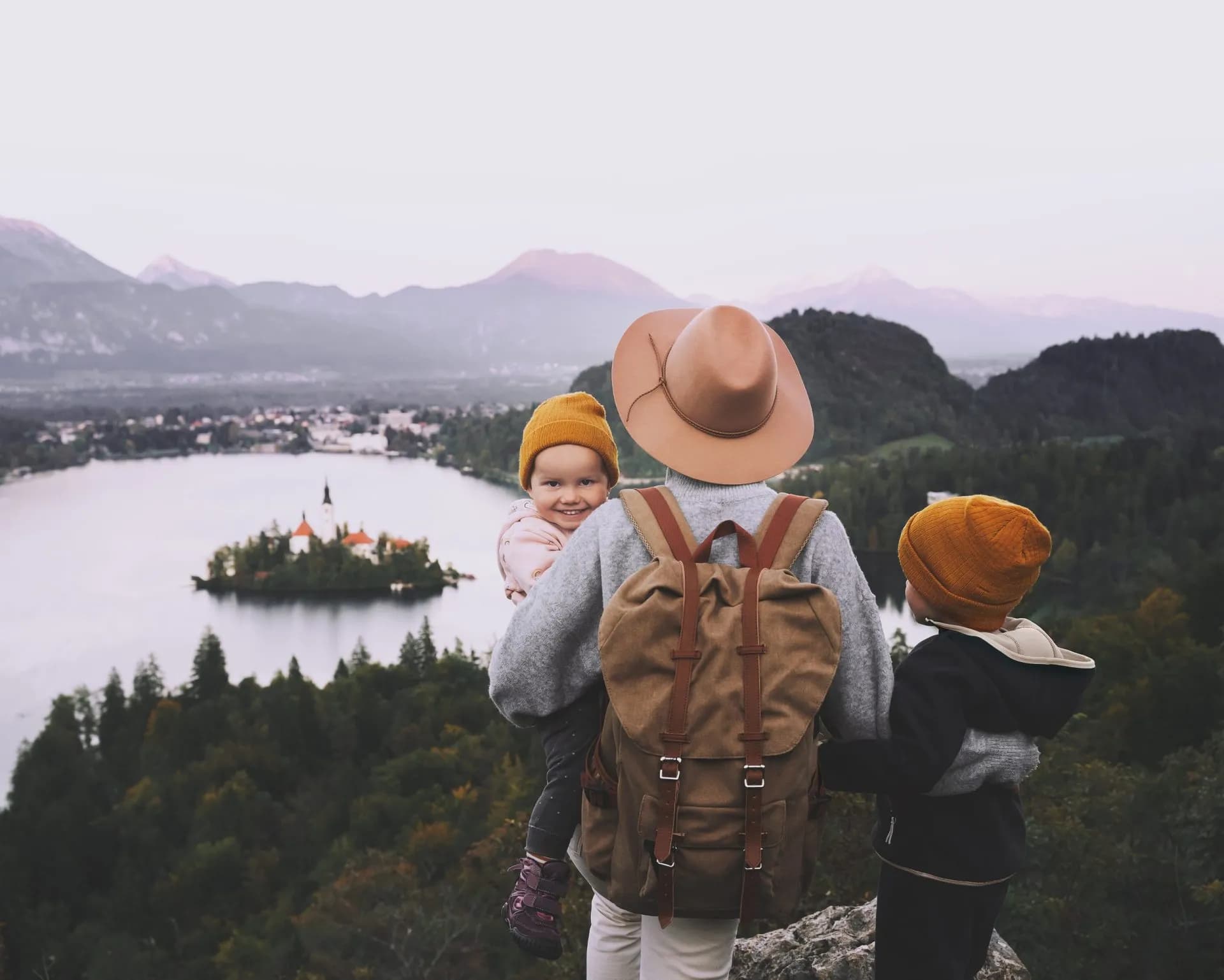 Family hiking overlooking Lake Bled island church and mountains in Slovenia