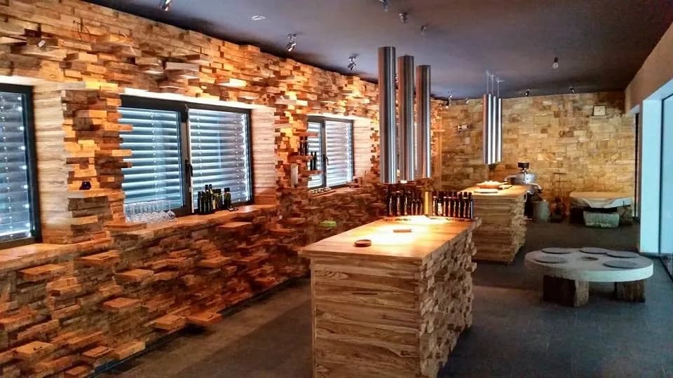 Tasting room interior with modern wood block walls, serving counters, and stainless steel ventilation pipes.