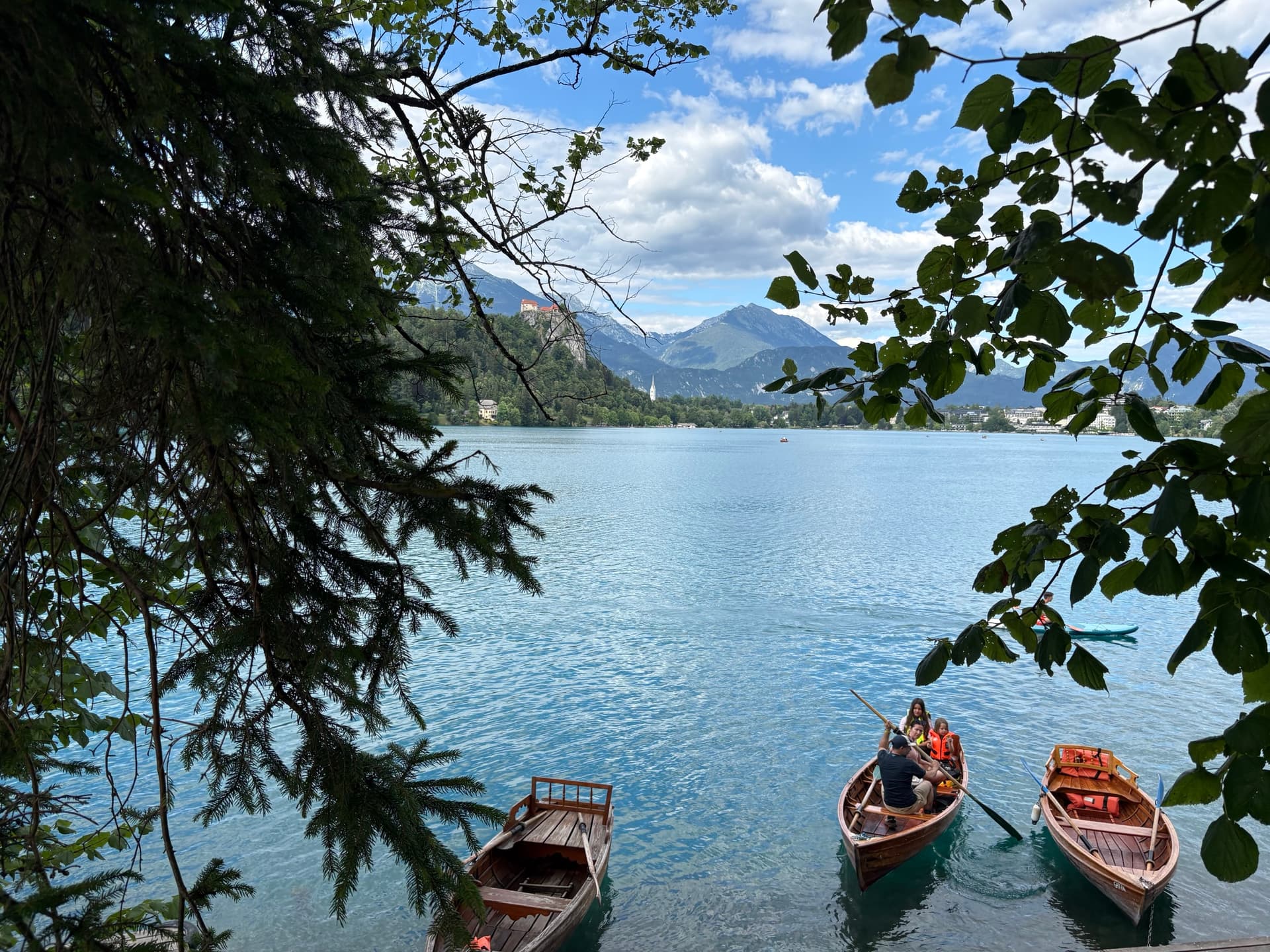 Traditional wooden rowing boats on Lake Bled with mountains in the background